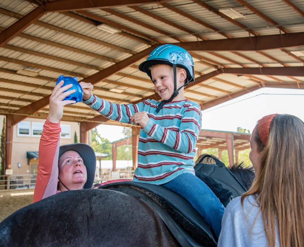 Occupational Therapy at The Shea Center is all about empowering individuals to build independence and enhance their quality of life. This means developing essential daily skills while experiencing the transformative impact of hippotherapy and hands-on tasks around the barn. 🐴
