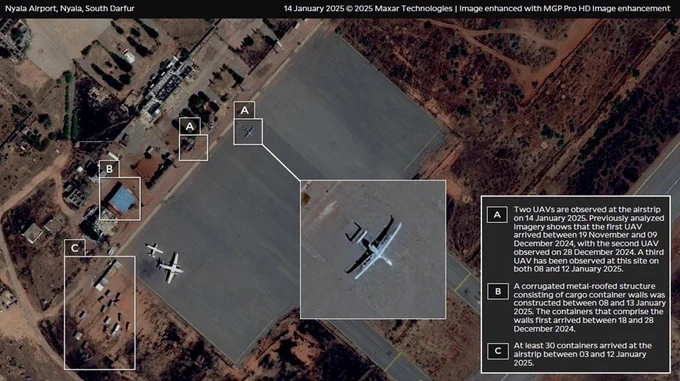 Title: Nyala Airport, Nyala, South Darfur 
Copyright: 14 January 2025 © 2025 Maxar Technologies | Image enhanced with MGP Pro HD image enhancement, Analysis by Yale HRL.
Text: (A) Two UAVs are observed at the airstrip on 14 January 2025. Previously analyzed imagery shows that the first UAV arrived between 19 November and 09 December 2024, with the second UAV observed on 28 December 2024. A third UAV has been observed at this site on both 08 and 12 January 2025. 
(B) A corrugated metal-roofed structure consisting of cargo container walls was constructed between 08 and 13 January 2025. The containers that comprise the walls first arrived between 18 and 28 December 2024. 
(C) At least 30 containers arrived at the airstrip between 03 and 12 January 2025.
