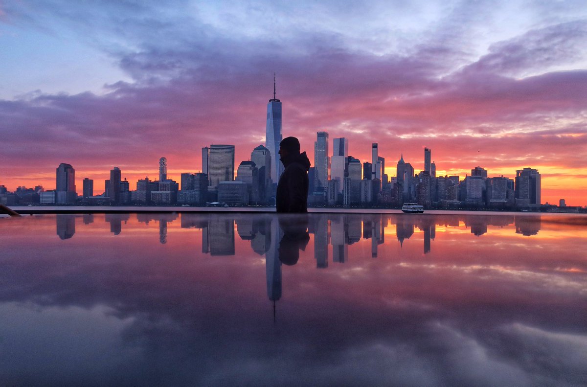 GaryHershorn's tweet photo. A cold morning as the sun rises behind lower Manhattan and One World Trade Center in New York City, Friday morning. #newyorkcity #nyc #newyork #sunrise https://t.co/HxWjzH0lE7