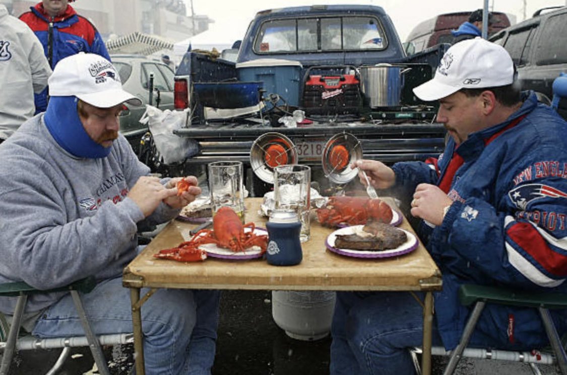 BOSthrowback's tweet photo. Patriots fans eating steak and lobster before a playoff game against the Colts (January 2004)

This is what peak happiness looks like for New Englanders https://t.co/gpd2J6QpxO
