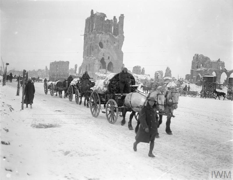 Horse-drawn transport column passing through the snow-covered square of Ypres, 8 January 19l8.© IWM Q 9803