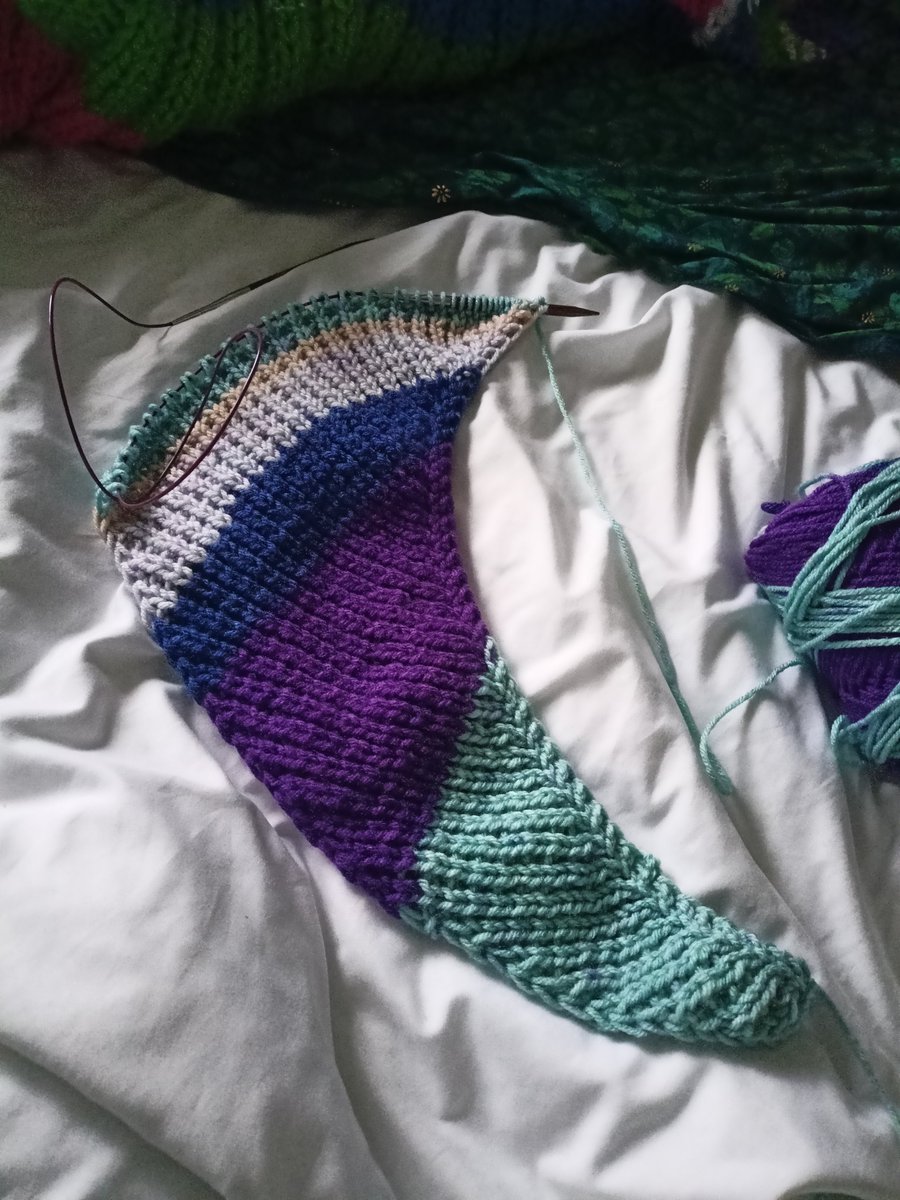 Feeling too poorly to manage much other than sit under a blanket and knit.
I love the shape of this scarf, watching the curve of it emerge as the rows increase.