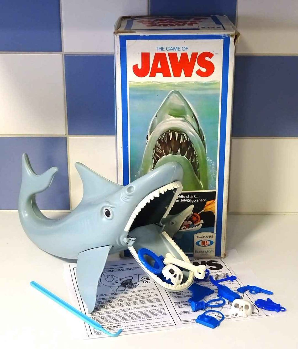 🦈 It’s the #70s and this shark just ruined your childhood. The JAWS game was all fun and games until it snapped your hand off. Who else still has trust issues because of this thing? 😂🐟 #JAWS #70sKids #SharkAttack 🦈🩸 #retro #retrohorror #johnsunshinetv #retrotoys #toys 😱
