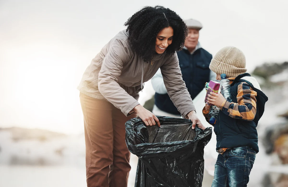 Beach cleaning, plastic and family with child volunteer for education, learning and community support. 
