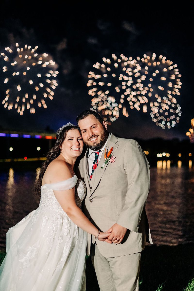 DisneyWedCast's tweet photo. Michael and Amanda slipped away from their Grand Floridian reception to take photos with Magic Kingdom's fireworks on the lawn around the corner from the Marina. https://t.co/bizpNrJxVD https://t.co/d79A4DnYiY