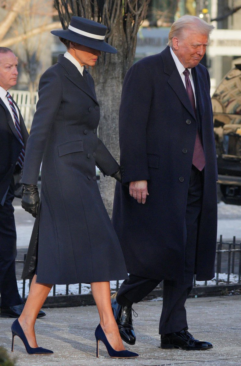 First Lady Melania Trump wore a custom double-breasted navy coat by Adam Lippes and a matching boater hat by Eric Javits, both American designers, for this morning’s church services as part of Inauguration ceremonies.

She completed this impeccable look with black leather gloves