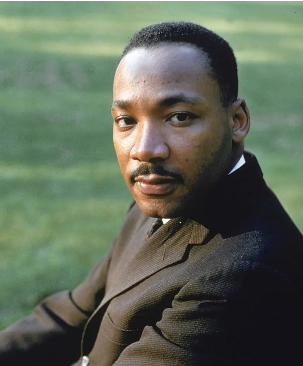 A color portrait photograph of  Martin Luther King Jr. taken at Atlanta University in 1963.