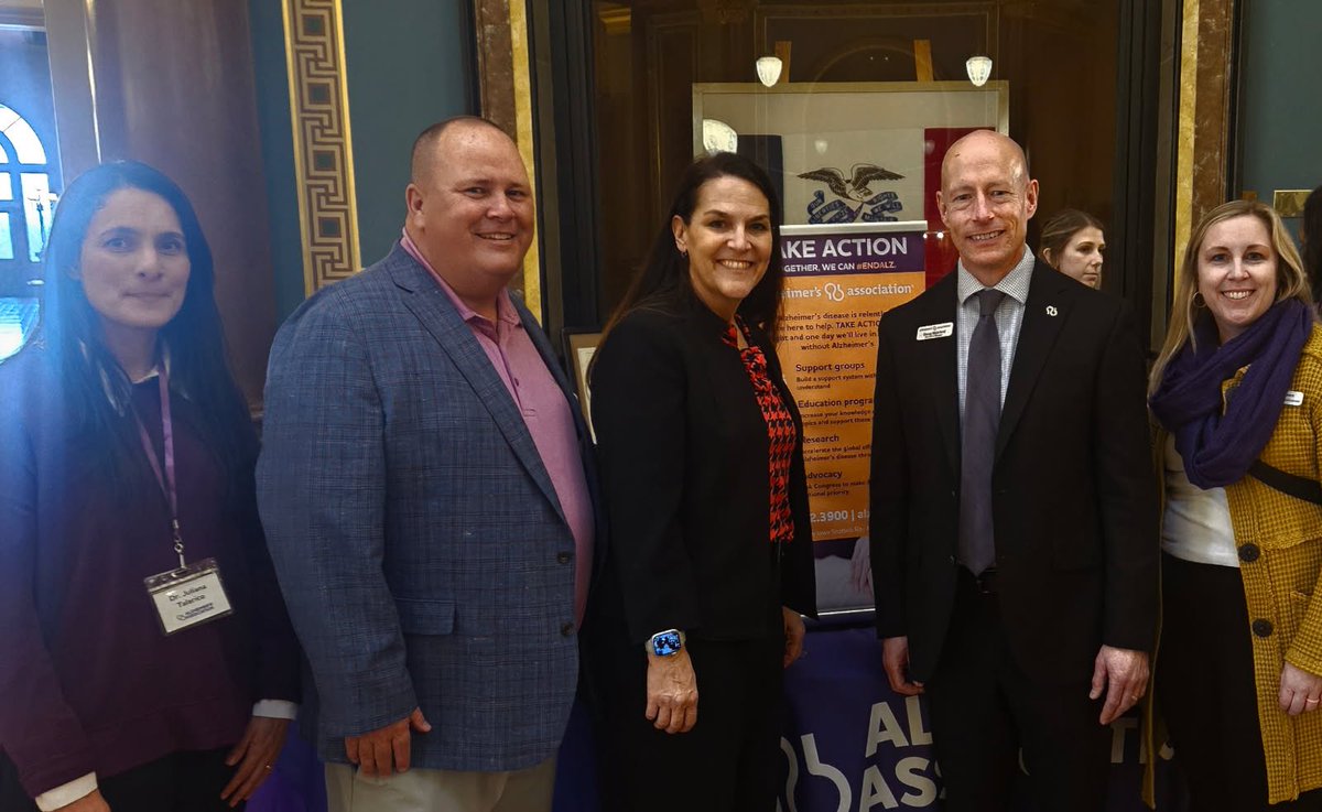 IALtGov's tweet photo. Members of the Alzheimer’s Association were at the Capitol promoting increased research and ways to help families connect to resources and treatments for their affected loved ones. Pictured in the photo are Dr. Juliana Souza Talarico (U of I researcher and Alzheimer’s Iowa Board member), Tim Lane (Edward Jones, Alzheimer’s Iowa Board Member), Doug Bickford (Executive Director, Alzheimer’s Iowa), and Megan Olsen (Alzheimer’s Iowa Staff). @alzIOWA