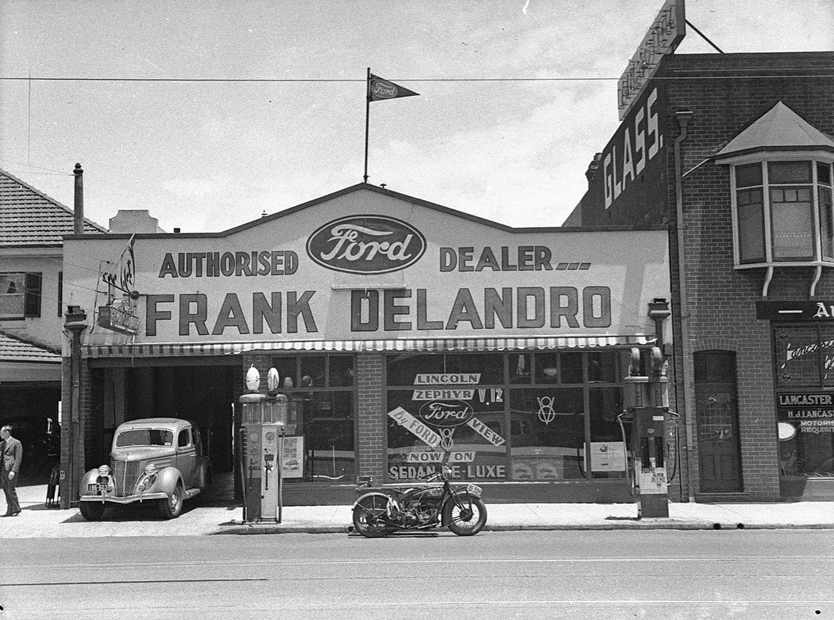 Geoffmuse's tweet photo. Frank Delandro - authorised Ford dealer, shopfront with Indian motorcycle and petrol bowsers, Crows Nest, North Shore, Sydney, 17 Dec 1936, by Sam Hood. Uploaded to #Flickrcommons by @StateLibraryNSW https://t.co/ir9lxzOdyk https://t.co/9oaUzKhRcV
