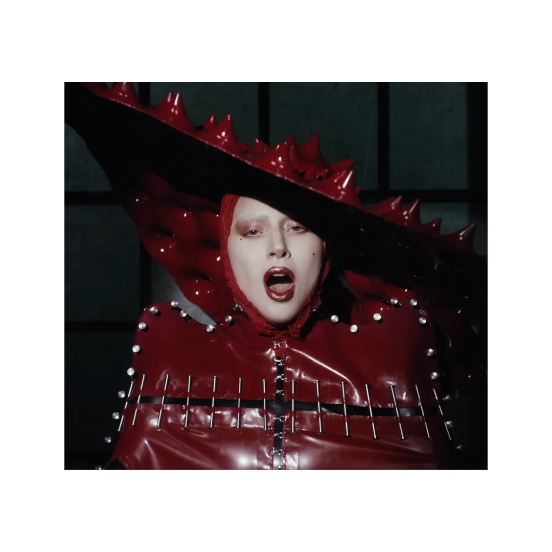 Lady Gaga's "Abracadabra" crimson latex cape with nails was custom-made for  her by NYC-based latex artisan @ReneeMasoomian!