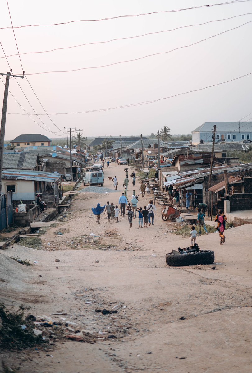 Tunde_OD's tweet photo. To the dreamers who left home…

I recently returned to the place in Ikorodu where I lived the first 20 years of my life. For the longest time, I hesitated to go back, unsure if I was ready to confront the flood of nostalgia and the weight of the memories I had suppressed. But after two years of filming a documentary about my journey, it was finally time to revisit the starting point of it all.

As we drove down the same streets I once raced through barefoot as a child, it felt like everything had shrunk to a miniature scale. The rustic roofs, the muddy streams, the dump sites, the old friends, the first girl I ever loved, the barber’s shop where I saw a chess board for the very first time, the church where I learned to play the piano—remained unchanged, as if time had stood still and became a museum of who I’d been.

Standing by the river where we once bathed as kids, I remembered the night I left. It was a cold evening in 2015: unable to renew the rent, my Dad had to return to the village to work in a bakery, my Mum took a job as a cleaner. I had no place to call home anymore. With my bags clutched tightly and tears welling in my eyes, I left behind the only life I had ever known. Terrified of the uncertainty ahead but with the will to fight for my place in the world.  I carried a piece of home with me with unwavering faith in my ideas.

It’s been 10 long years. Now, I have returned—not the same, but better—ready to leave a piece of my heart with the children here who, like me, are still dreaming .

It is the only way I can honor the privilege of who I have become.

To every dreamer who left home in pursuit of wonder, I know the hurt of those cold lonely nights and the loss of everything that was familiar . But I hope you never look back with regret. You must let your courage be your compass as you re-write your own story of becoming . You are growing into someone capable of holding the best of your past alongside the boundless potential that is in front of you. This is especially important if where you’re coming from is worlds apart from where you’re going. 
Your fight is a different one.

Home is not lost, it is growing alongside your story—because sometimes, the place where you’re born isn’t where you belong; you belong where you believe you belong….where is that place for you?

And when your battles are finally won, I hope you can look back on your journey with awe and gratitude. 
And like my mother would always tell me 
“Babatunde mi, ranti Omo eni tiwo nse”(wherever the wind takes you, you must remember the child of whom you are)

For the ones who left home to find themselves, must someday return to give themselves away.

Keep going dreamer. I hope you never stop giving the world something new to believe in.