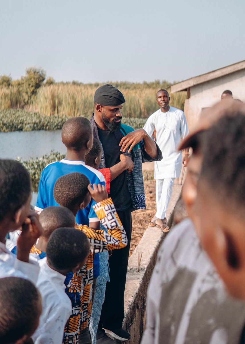 Tunde_OD's tweet photo. To the dreamers who left home…

I recently returned to the place in Ikorodu where I lived the first 20 years of my life. For the longest time, I hesitated to go back, unsure if I was ready to confront the flood of nostalgia and the weight of the memories I had suppressed. But after two years of filming a documentary about my journey, it was finally time to revisit the starting point of it all.

As we drove down the same streets I once raced through barefoot as a child, it felt like everything had shrunk to a miniature scale. The rustic roofs, the muddy streams, the dump sites, the old friends, the first girl I ever loved, the barber’s shop where I saw a chess board for the very first time, the church where I learned to play the piano—remained unchanged, as if time had stood still and became a museum of who I’d been.

Standing by the river where we once bathed as kids, I remembered the night I left. It was a cold evening in 2015: unable to renew the rent, my Dad had to return to the village to work in a bakery, my Mum took a job as a cleaner. I had no place to call home anymore. With my bags clutched tightly and tears welling in my eyes, I left behind the only life I had ever known. Terrified of the uncertainty ahead but with the will to fight for my place in the world.  I carried a piece of home with me with unwavering faith in my ideas.

It’s been 10 long years. Now, I have returned—not the same, but better—ready to leave a piece of my heart with the children here who, like me, are still dreaming .

It is the only way I can honor the privilege of who I have become.

To every dreamer who left home in pursuit of wonder, I know the hurt of those cold lonely nights and the loss of everything that was familiar . But I hope you never look back with regret. You must let your courage be your compass as you re-write your own story of becoming . You are growing into someone capable of holding the best of your past alongside the boundless potential that is in front of you. This is especially important if where you’re coming from is worlds apart from where you’re going. 
Your fight is a different one.

Home is not lost, it is growing alongside your story—because sometimes, the place where you’re born isn’t where you belong; you belong where you believe you belong….where is that place for you?

And when your battles are finally won, I hope you can look back on your journey with awe and gratitude. 
And like my mother would always tell me 
“Babatunde mi, ranti Omo eni tiwo nse”(wherever the wind takes you, you must remember the child of whom you are)

For the ones who left home to find themselves, must someday return to give themselves away.

Keep going dreamer. I hope you never stop giving the world something new to believe in.