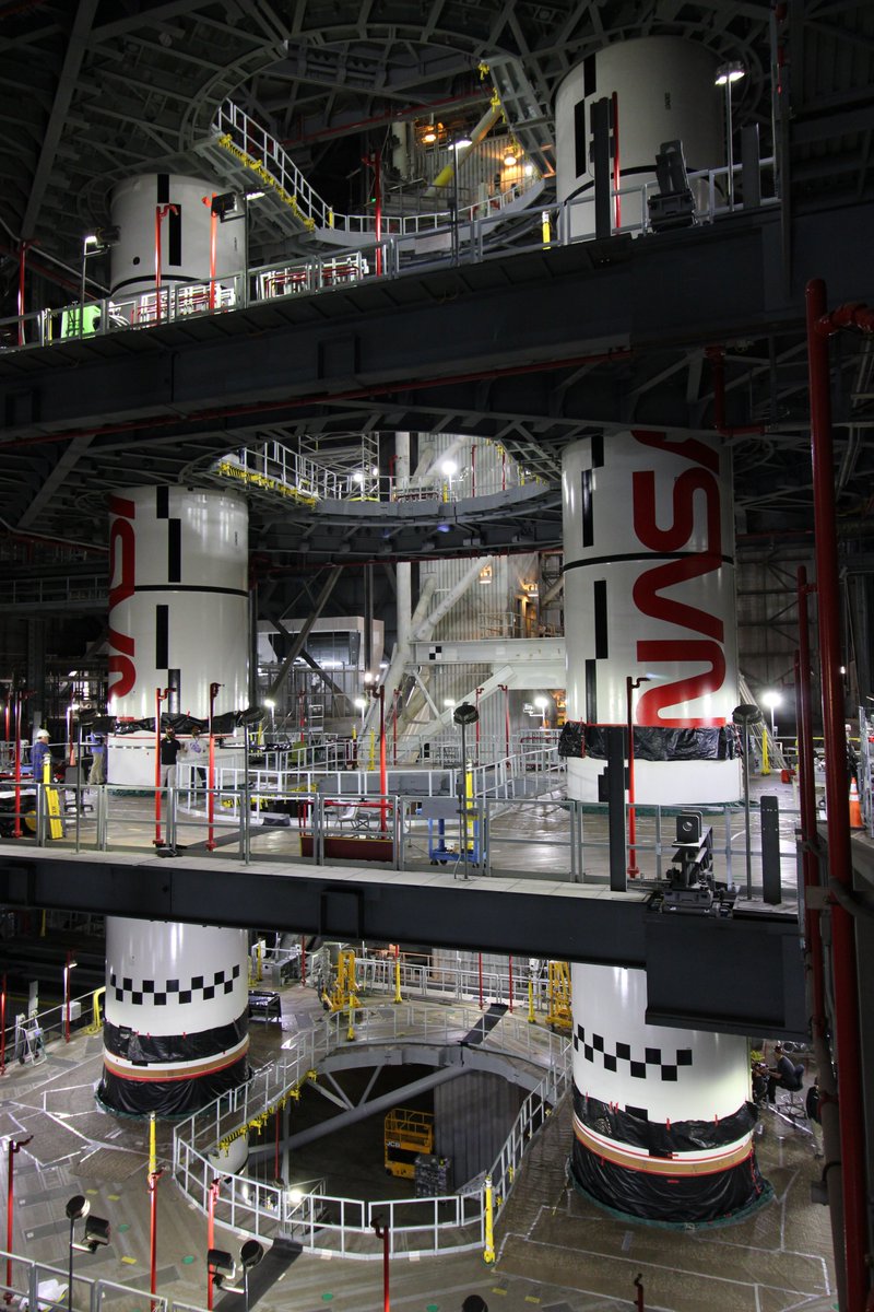 NASAGroundSys's tweet photo. Up (and over) next is the left forward center segment!

Last week, teams lifted another @NASA_SLS solid rocket booster segment up in the Vehicle Assembly Building transfer aisle and over onto mobile launcher 1 in High Bay 3. To complete booster stacking for the @NASAArtemis II mission, teams will lift two more motor segments and two cone-shaped forward assemblies.