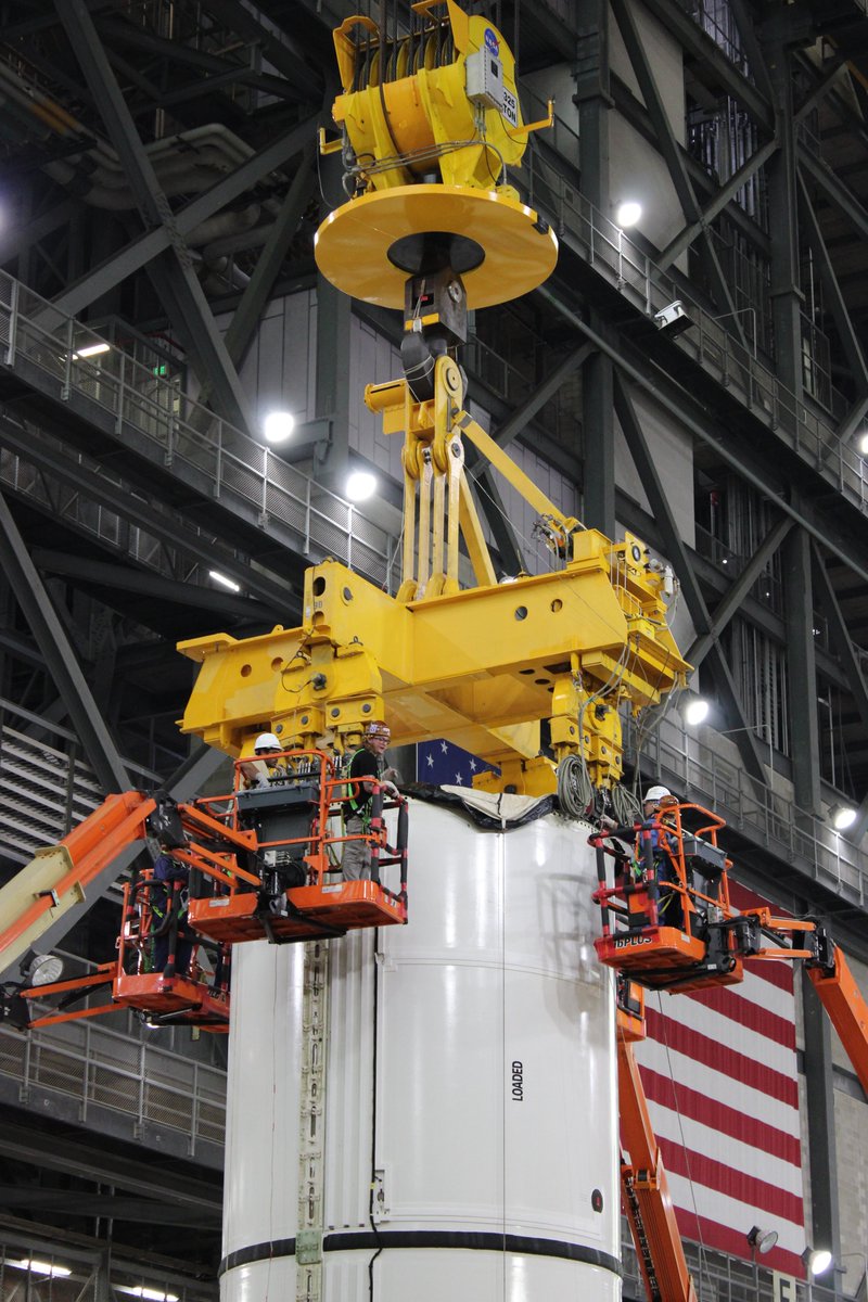 NASAGroundSys's tweet photo. Up (and over) next is the left forward center segment!

Last week, teams lifted another @NASA_SLS solid rocket booster segment up in the Vehicle Assembly Building transfer aisle and over onto mobile launcher 1 in High Bay 3. To complete booster stacking for the @NASAArtemis II mission, teams will lift two more motor segments and two cone-shaped forward assemblies.