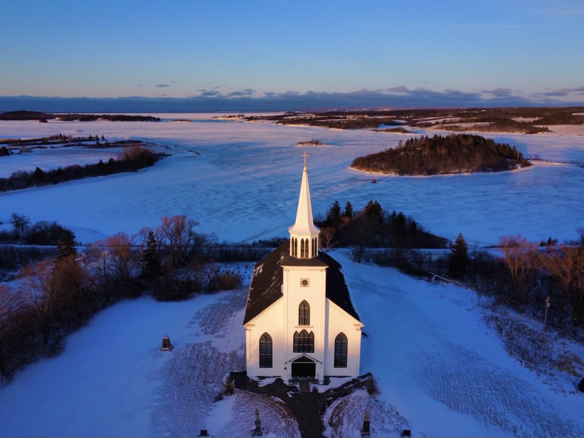 Warmth in the steel blue cold, Saint Peters’s church, Tracadie, Nova Scotia  #sunset #novascotia # church #drone #tracadie