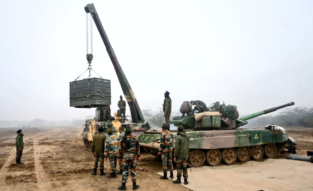 SWComd_IA's tweet photo. Displaying the resolve of steel, " Black Charger Eagles" undertook a 24 hrs continuous engine changing excercise wherein engines of one T-90, One T-72 and One BMP  were changed overnight. 

Braving cold temperatures, rains and  poor visibility, the team not only validated it's "Combat Force Regeneration" capability but also reaffirmed technical prowess.

#NationFirst
#IndianArmy 
#SaptaShaktiCommand 
#BlackChargerBrigade 
#TechForDefence 

@adgpi 
@HQ_IDS_India
@SpokespersonMoD
@IAF_MCC
@Indiannavy
@PRODefRjsthn