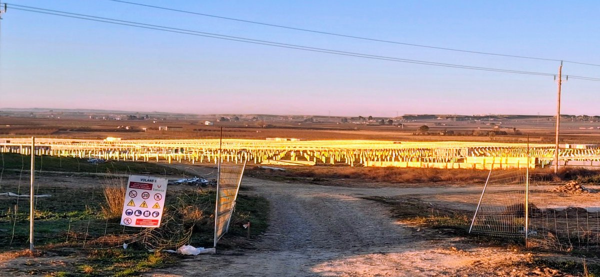 Com un sol a la terra. Aquest camp que sembla que s'encengui és el reflexe del sol sobre els postes que aguantaran només uns milers de plaques solars. Ara imaginem-ne 800 hectàrees amb les plaques a sobre. I al mig de la zona fructícola més important d'Europa. Renovables així no.