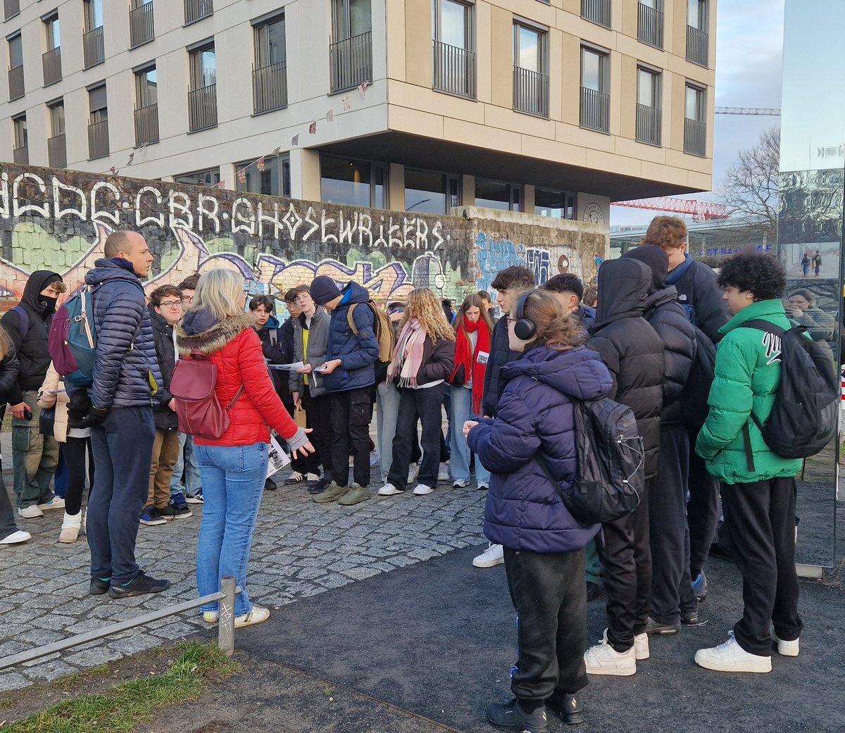 GCS_History's tweet photo. Mrs Staunton and Mr Houghton sharing the history of the Berlin wall before students explore the East Side Gallery graffiti art https://t.co/c7TaHr2rYX