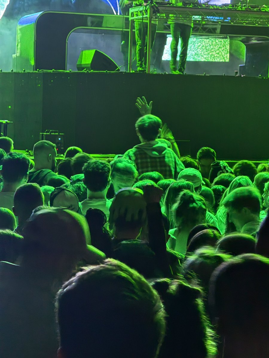 Based on scale of the other concert goers… how tall is this man? We were thinking at least 6’7’’