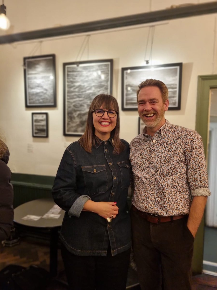 AlexSThornton's tweet photo. Delighted to have met @LizAtkin last night and heard her speak, what an inspiration. After following on here and wanting her work on my wall, my friends bought one for my birthday! Can't wait to hang it. Thank you Liz and my pals. (I got the one behind us) https://t.co/VuXdfMwTAI