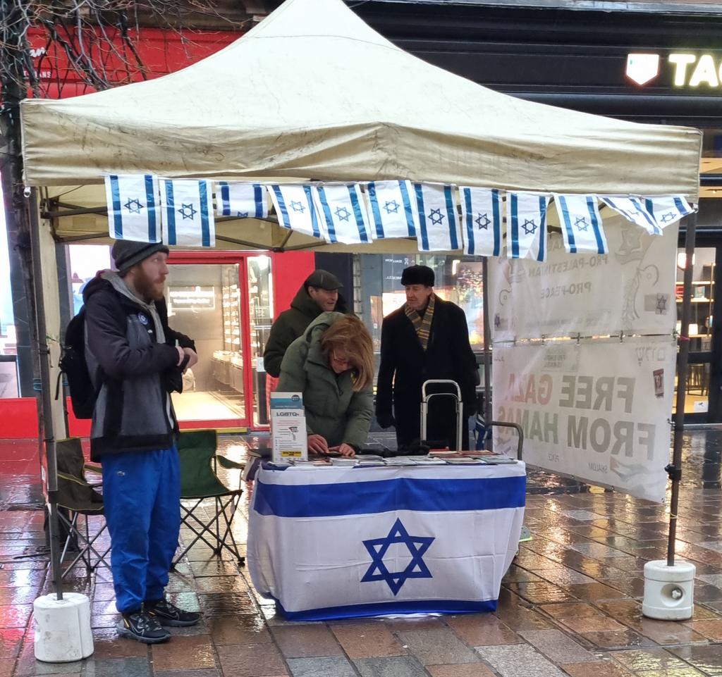 GlasgowFOI's tweet photo. Very wet morning in Glasgow, but our peace stall is up and running.

Another four hostages due to be released, and we pray that will go smoothly.

#StandWithIsrael 
#AmYisraelChai 
#BringThemHome https://t.co/IptjJHFo3G