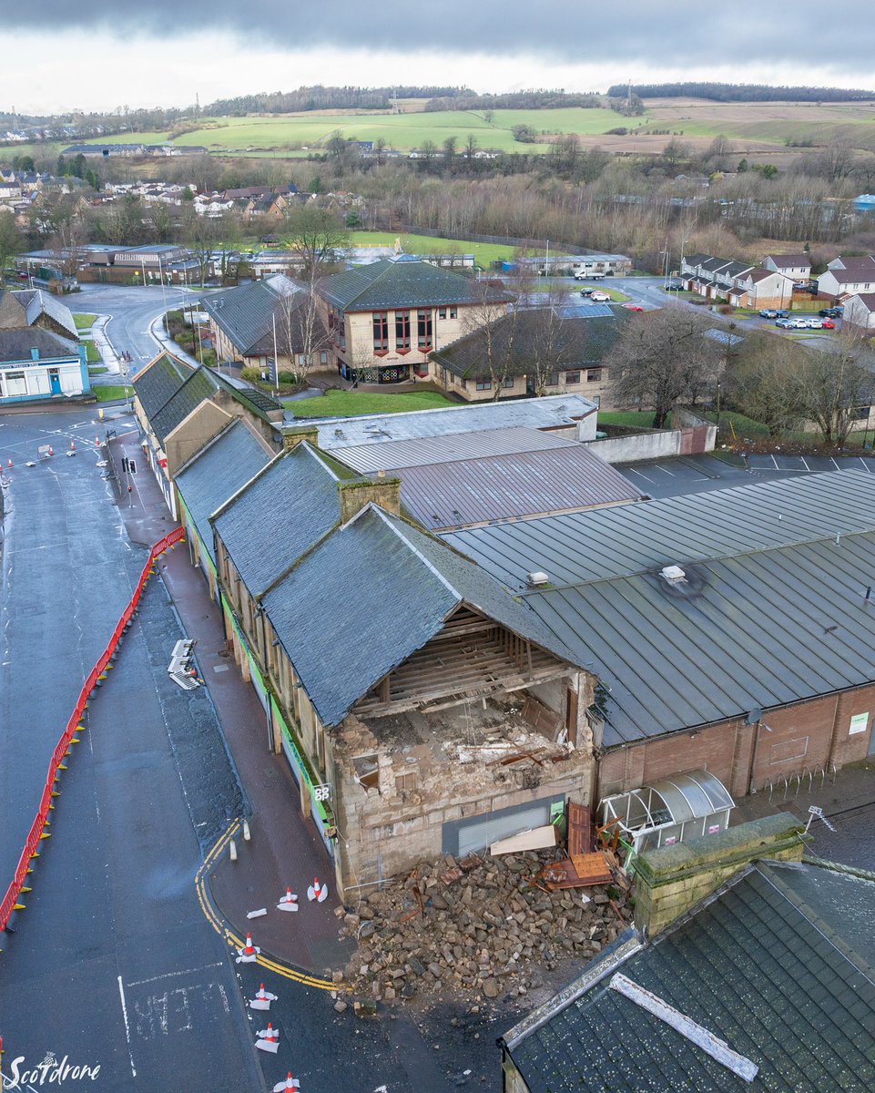 scotdrone's tweet image. The aftermath of Storm Eowyn on Denny in the Falkirk area with severe damage to the CO-OP Supermarket on Stirling Street in the town centre. #denny #falkirk #scotland #storm #StormEowyn