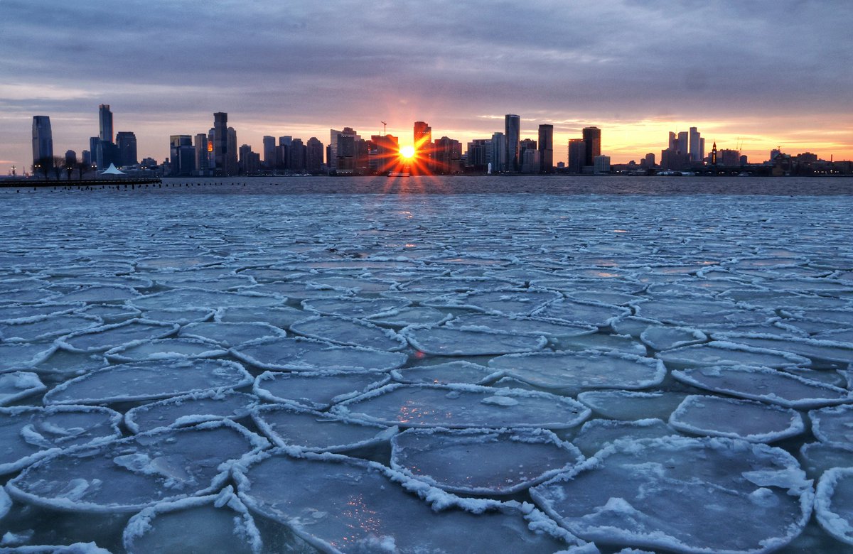 GaryHershorn's tweet photo. Ice floating in the Hudson River in New York City as the sun sets behind the skyline of Jersey City, NJ, Saturday evening #newyorkcity #nyc #newyork #sunset #icefloe https://t.co/71YiBgGn1x