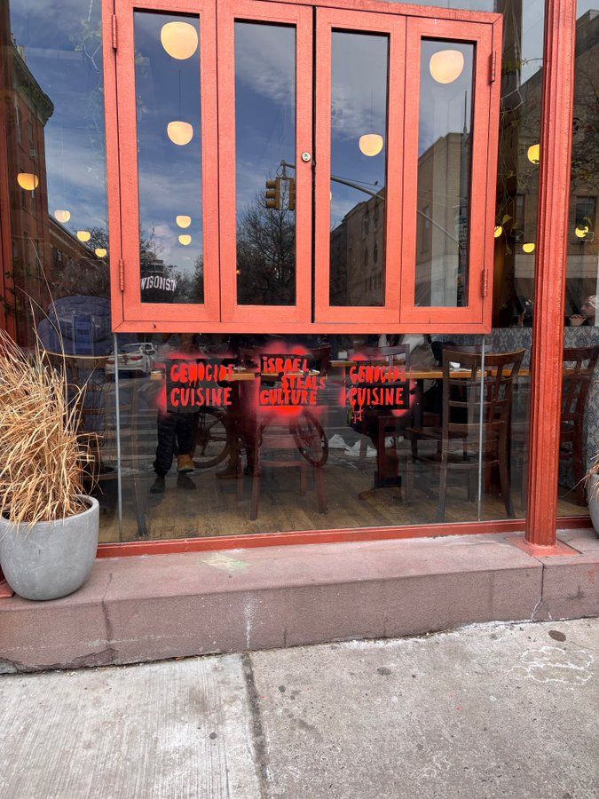 HenMazzig's tweet photo. Miriam, a popular Israeli restaurant in Brooklyn, was vandalized this morning with “Israel steals culture” and “genocide cuisine.”

Not only is this vandalism a disgusting act of anti-Jewish hatred, but the insinuation that Israelis don’t have cuisine and culture is dehumanizing.

Israeli food isn’t “stolen”—it’s the heritage of 850,000 Jewish refugees who were violently expelled from the Middle East.

On the eve of Holocaust Memorial Day, this bigotry—accusing Jews of genocide and cultural theft—is especially disturbing.