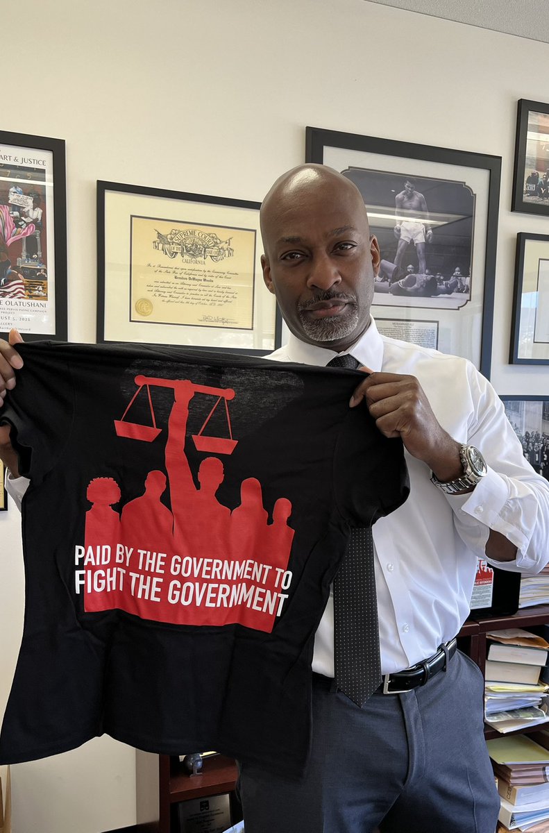 Brendon Woods (@brendonwoodspd) on Twitter photo New year, new shirt. No matter what <a href="/POTUS/">President Donald J. Trump</a> throws at us, we’re ready. We will fight for our clients. We’ll fight for your rights. We will fight to protect our immigrant community members. Paid by the government, to fight the government, we fight for you! #WeFightForYou #Defenders New year, new shirt. No matter what <a href="/POTUS/">President Donald J. Trump</a> throws at us, we’re ready. We will fight for our clients. We’ll fight for your rights. We will fight to protect our immigrant community members. Paid by the government, to fight the government, we fight for you! #WeFightForYou #Defenders
