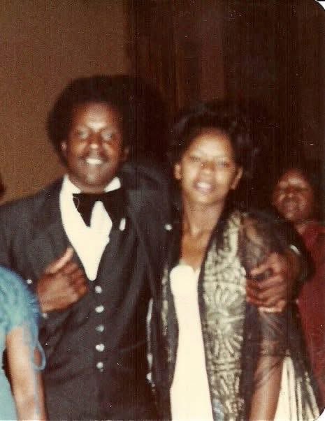 Can someone fix this picture for me? Make my parents faces clear and not blurry and remove the persons arm and remove the lady in the background. This is the only picture I have of my parents together.