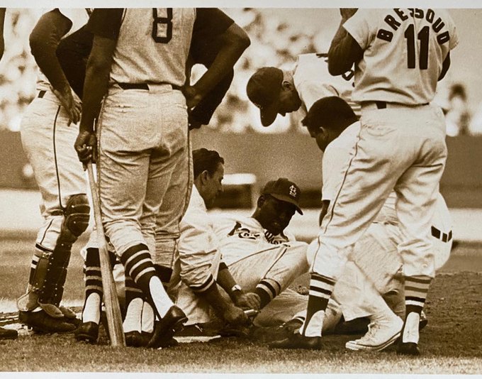 Bob Gibson grimaces in pain after being hit by a line drive off Roberto Clemente's bat. Gibson had a broken leg and continued pitching to three more batters, .July 15, 1967, After being hit, Gibson faced Willie Stargell (who he walked), Bill Mazeroski (who popped out), and Donn