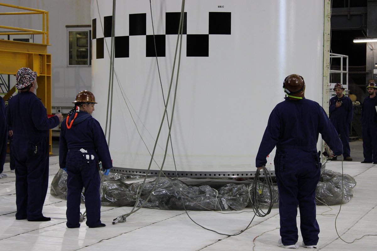NASAGroundSys's tweet photo. Raising the roof! 🏘️

Before stacking each segment, teams attach a joint roof enclosure. When the new segment is lowered over an already-stacked segment, teams will unroll the roof material to create a tent around the joining segments. This creates a clean room and temperature-controlled environment for the hard mate portion of the stacking process, when the segments are pinned together.