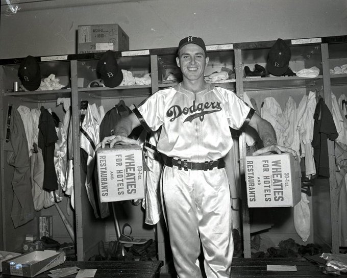 Gil Hodges holding two large boxes of Wheaties in the Dodgers Satin uniform. Brooklyn Dodgers: Introduced powder blue and white satin uniforms in 1944-1945 to enhance visibility during night games due to their reflective properties. Other teams also experimented with these