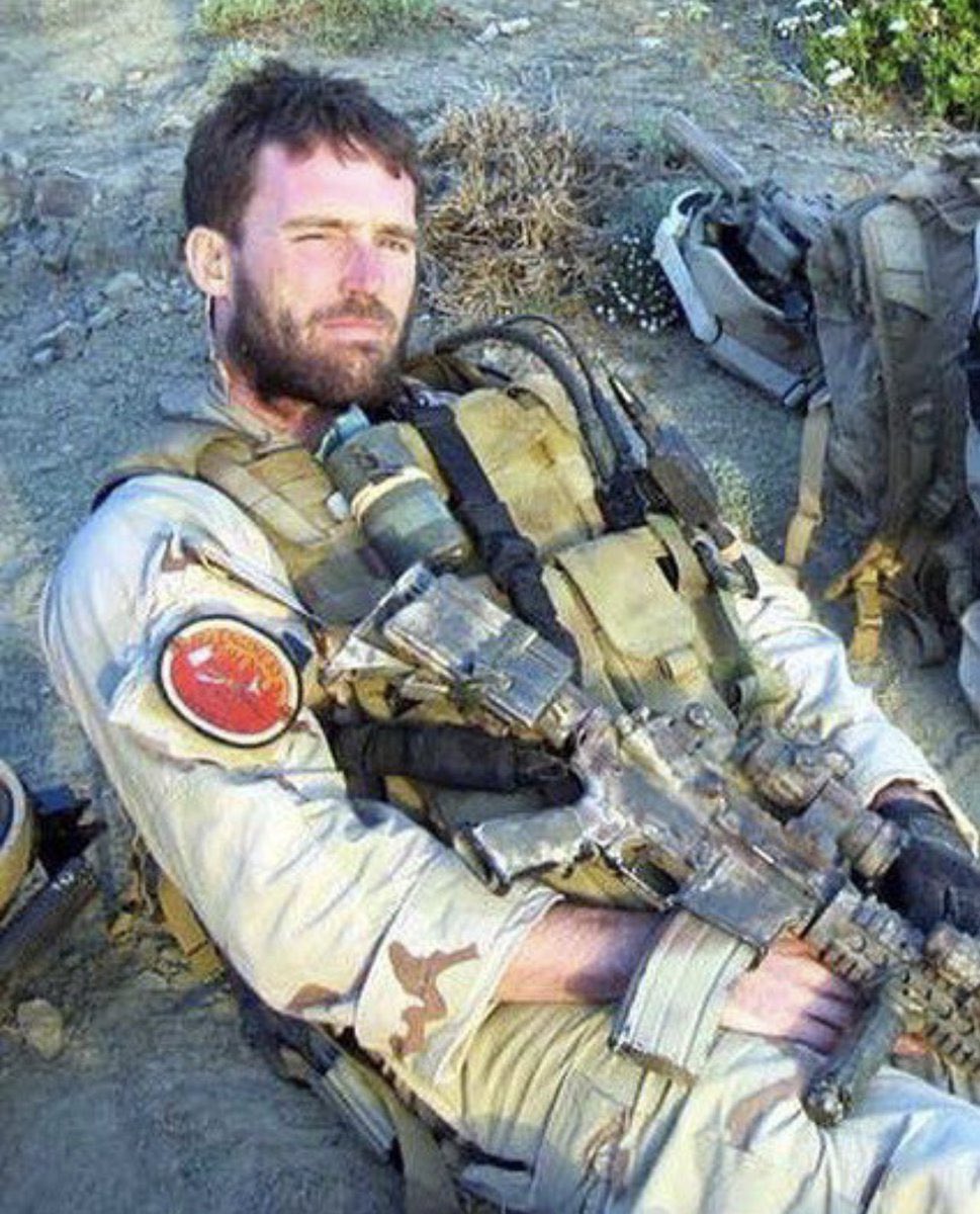 Fallen Navy SEAL Michael P. Murphy in
Afghanistan, 2005. He wears a FDNY patch used to commemorate firefighters who lost their lives on 9/11.