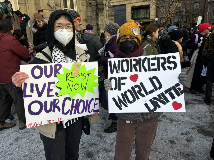 Grad workers hold signs at the March