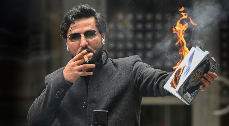 nexta_tv's tweet photo. ‼️ BREAKING: The organizer of Quran-burning protests shot dead at his home in Sweden during live-streaming on TikTok

Salwan Momika's body was found in a house in a Stockholm suburb with gunshot wounds, reports SVT. On Thursday, Momika was supposed to hear the verdict in a case involving incitement to racial hatred. The Stockholm District Court postponed the sentencing, as "one of the defendants has died." Police have not yet confirmed the man's identity. SVT writes that Swedish intelligence services have been involved in the investigation.  

The publication GP reports that Momika was live-streaming on TikTok at the time of the shooting, which was later interrupted by a police officer.  

Momika gained notoriety for his protests, during which he burned the Quran as a demonstration against Islam. In the summer of 2023, he publicly burned a Quran in the center of the capital, sparking mass protests in Iraq—protesters even stormed the Swedish embassy. In his hometown of Al-Kufa, a bounty of $2 million and a golden Quran has been placed on his head.