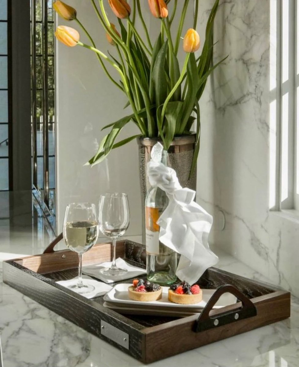 ANISTON- a vase by master glass artist Doug Frates of Ohio. ARJAY-a tray, also made in Ohio. Tray is a rich combination of walnut, white oak, domestic leather, genuine alligator, and stainless steel. Pure sophistication. Made in USA! 
Available: valoramericanhome.com/shop/accessori…