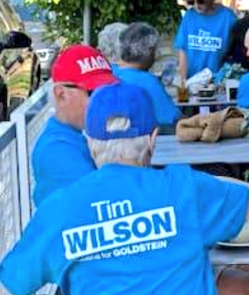 anth0888's tweet image. I'm sure Tim Wilson @tw4goldstein  will care to reconcile to Goldstein voters how he's claiming to be a "moderate" and yet locals photographed some of his close campaigners - wearing blue Tim Wilson campaign shirts - wearing a red Trumpian "MAGA" hat on Wednesday. #auspol