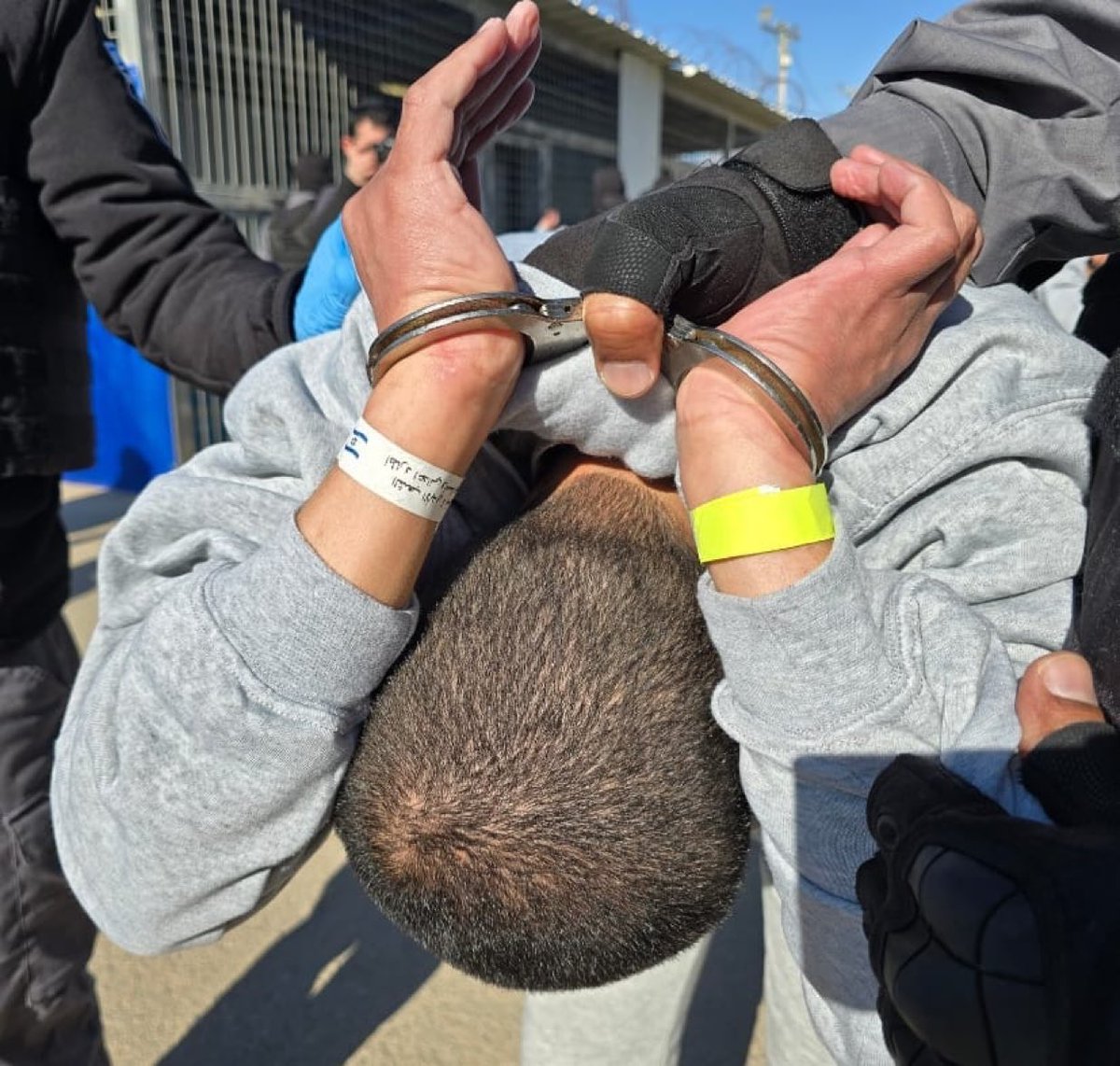 SuppressedNws's tweet photo. Why is everyone silent now?

A Palestinian hostage being released from an Israeli prison, handcuffed, dragged, and forced to wear a bracelet featuring the symbol of Israel and the Shin Bet (Shabak), inscribed with the words: “The eternal nation does not forget. I will pursue my enemies and overtake them.”