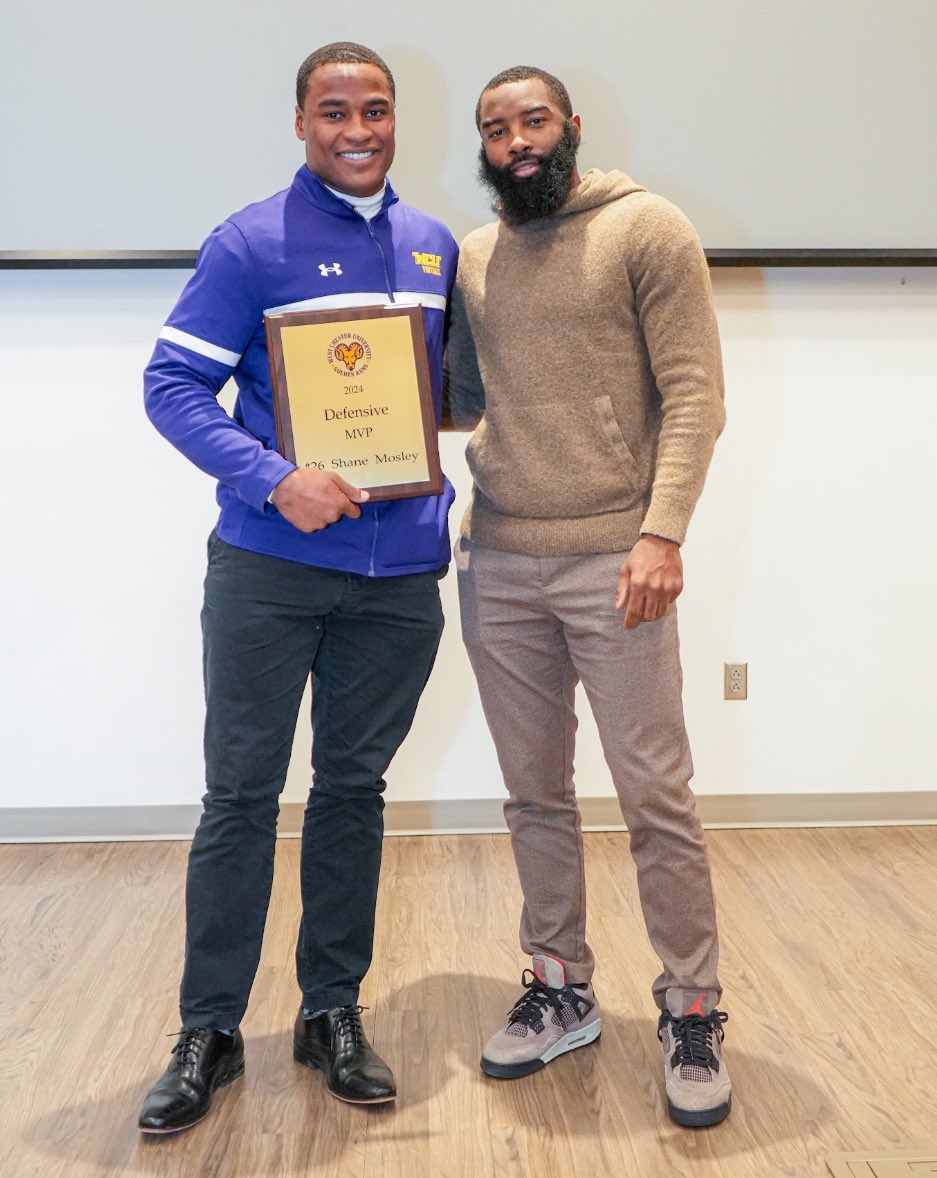 Nydair Rouse (Class of 2018) presented Senior Safety Shane Mosley with the Defensive MVP Award.