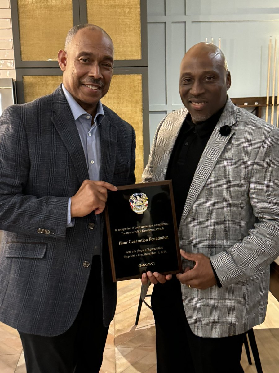 Mr. James Robinson, Sr. (father of James '12) received a service award, on behalf of the Hour Generation Foundation (Jerami Grant '12) from the City of Bowie’s Chief of Police Dwayne A. Preston '87. The foundation has been a supporter for the 'Shop with a Cop' event in the city.