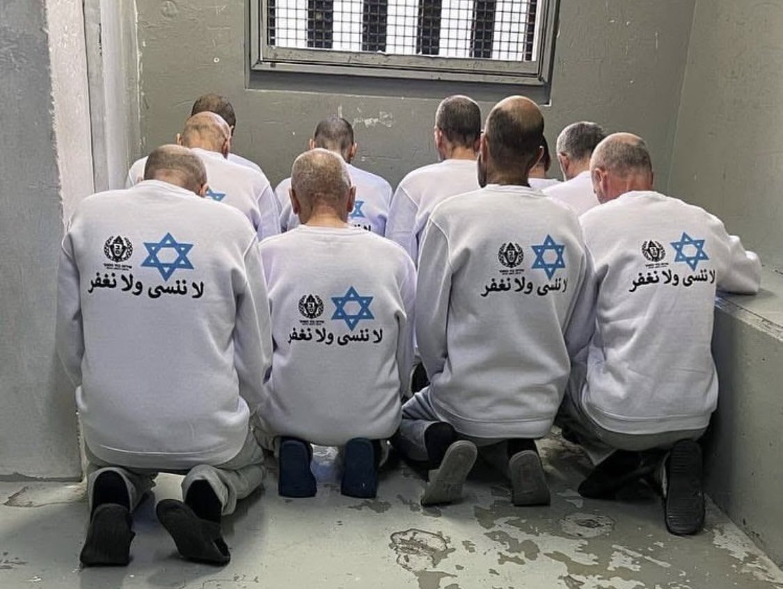 VigilanteOps's tweet photo. Footage has emerged showing dozens of Palestinian detainees wearing shirts emblazoned with the Star of David and the slogan “We will never forget, we will never forgive” as they were released from Ofer Prison in the sixth round of the prisoner exchange deal between Israel and the resistance.