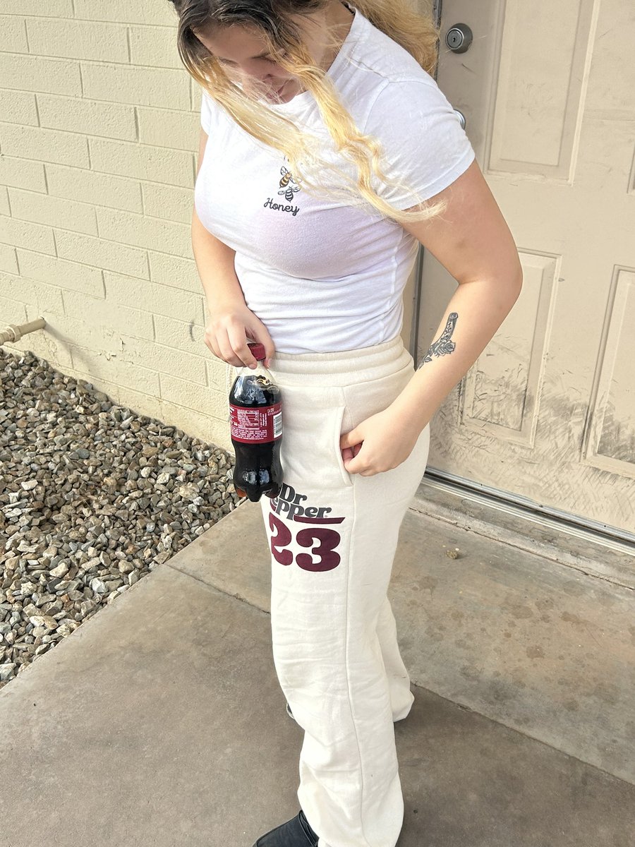 Holding a Dr Pepper with dr pepper pants lol
