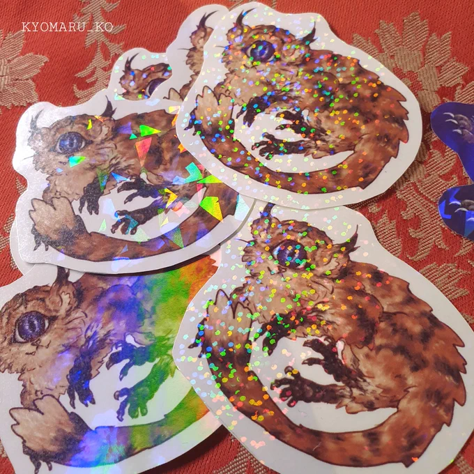 Sticker Showcase!  Tiggowls. They are one-eyed felines with raptor-like scaly claws and tufted ears. Their large eye can be used like a two-way projector lens, so it can reflect anything they have seen and show a "play back" for others to see. #creaturedesign 