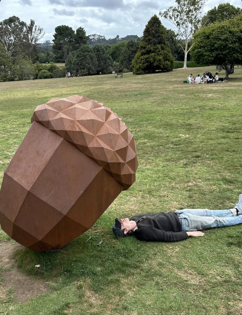 NEW | Mike laying down besides a giant acorn?