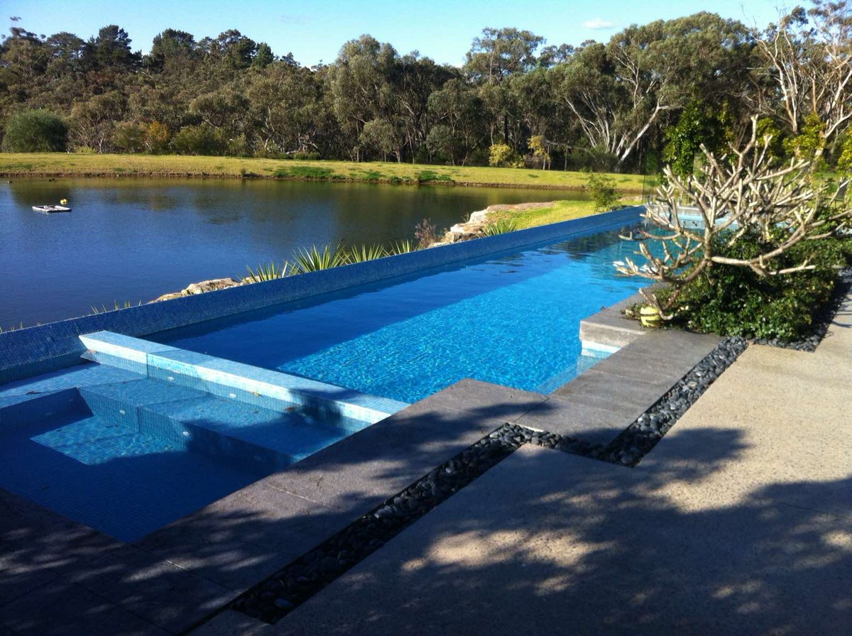 Creating the perfect poolside vibes, one tile at a time 🔹💧 #PoolDesign #TilingBeauty