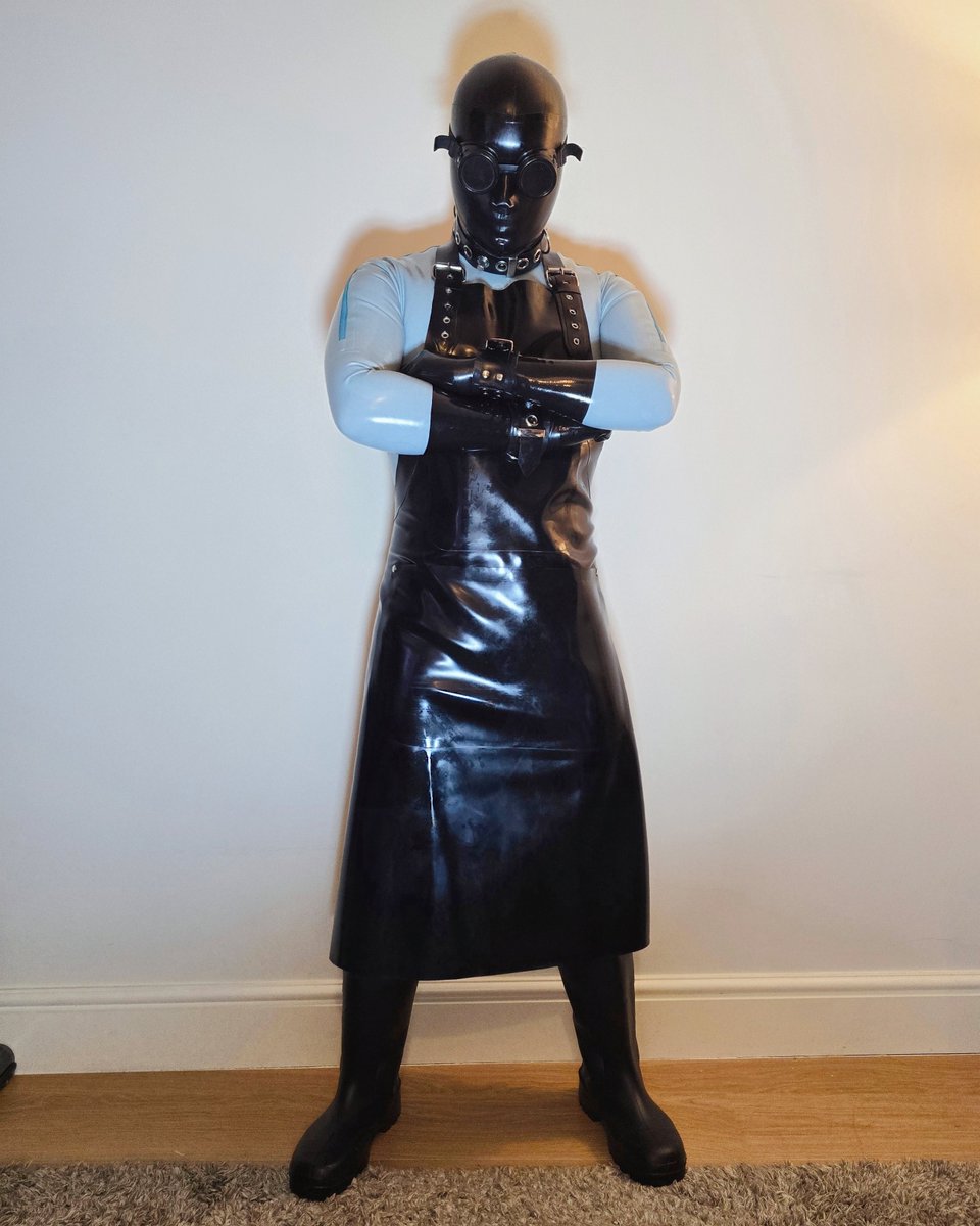 Rubber Medic (2) 

Their duty is to analyse the remaining survivors and, if they are fit, to "process" them into their own protective rubber suits. 
Rubbermedic-1473X is ready to "process" you now.