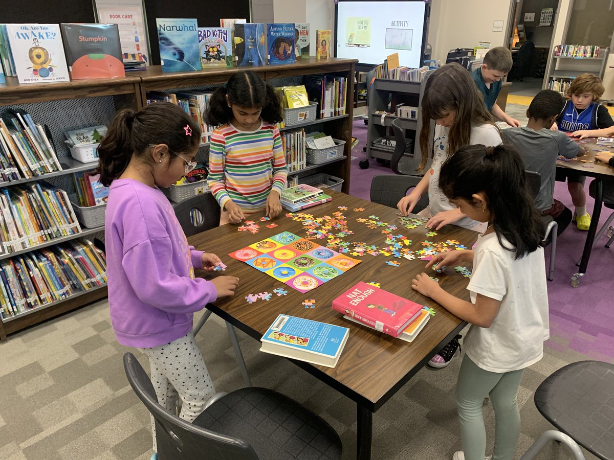Fun in the library:  Mrs. Biamont had puzzles for us today.