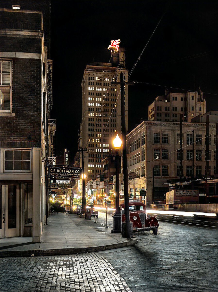 TracesofTexas's tweet photo. A view of downtown Dallas at night, 1942.  Note the Pegasus atop the Magnolia Hotel. I'm a little unsure of my bearings so I can't tell if this is Commerce Street or Main St. I THINK it's Commerce. In any case, a magnificent photo by Arthur Rothstein. https://t.co/jGUeLiesq6