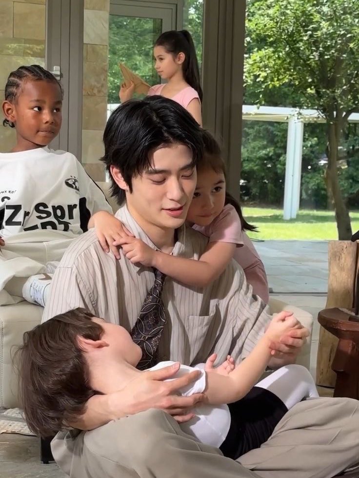 the way he holds the kids hand